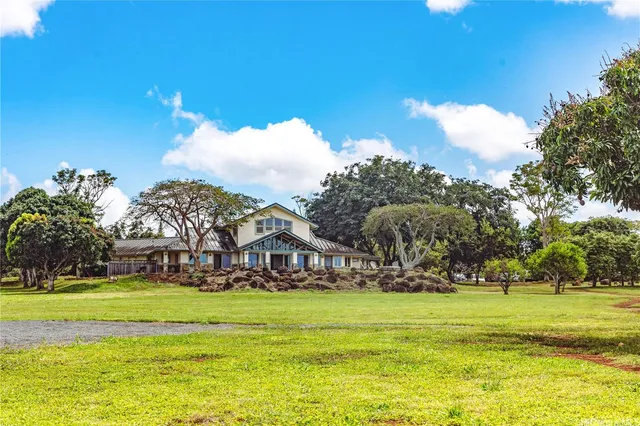 a view of building with garden and trees
