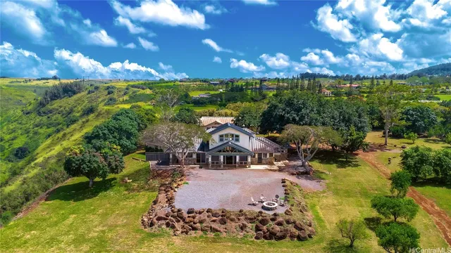 a aerial view of a house with yard swimming pool and outdoor seating