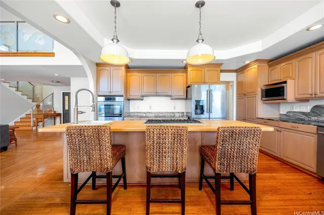 a dining room with furniture a chandelier and wooden floor