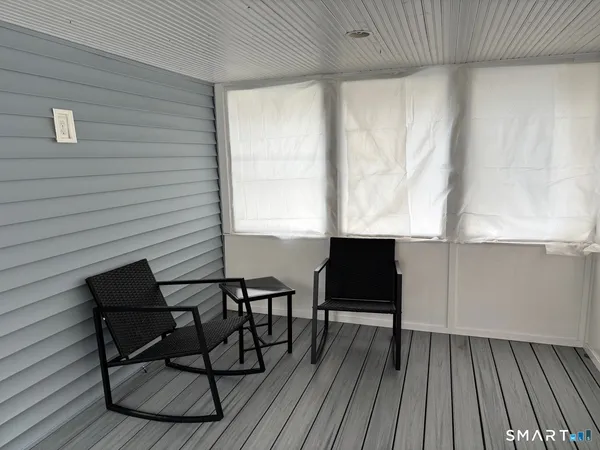 a balcony with table and chairs