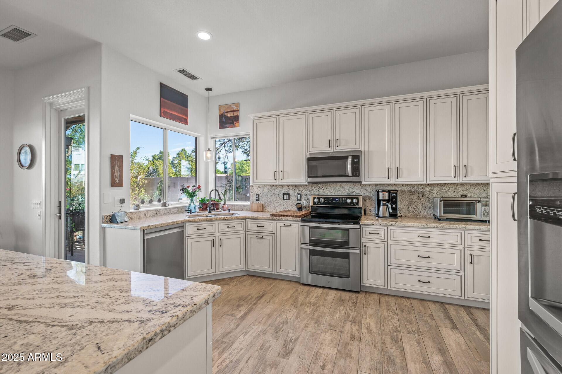 1626 East Kathleen Road Phoenix, AZ 85022 - Photo 18 of 47 a kitchen with granite countertop white cabinets and white appliances