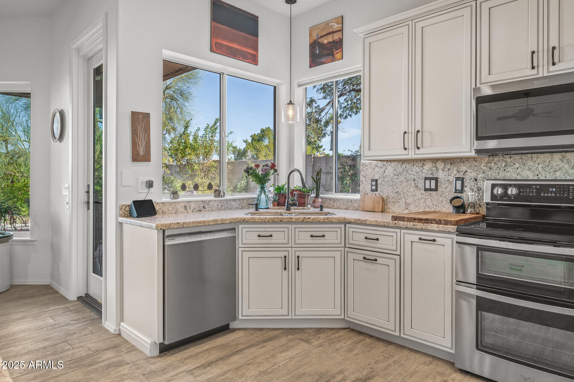 1626 East Kathleen Road Phoenix, AZ 85022 - Photo 19 of 47 a kitchen with white cabinets and appliances