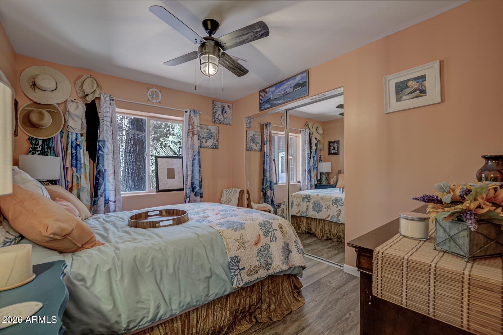 3762 Watertank Road Pine, AZ 85544 - Photo 18 of 38 a bedroom with a bed a dresser and paintings on the wall