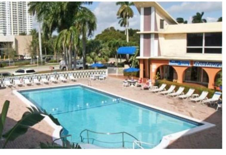 26 Diplomat Parkway, Unit 2314 Hallandale Beach, FL 33009 - Photo 1 of 15 a view of a swimming pool with a patio