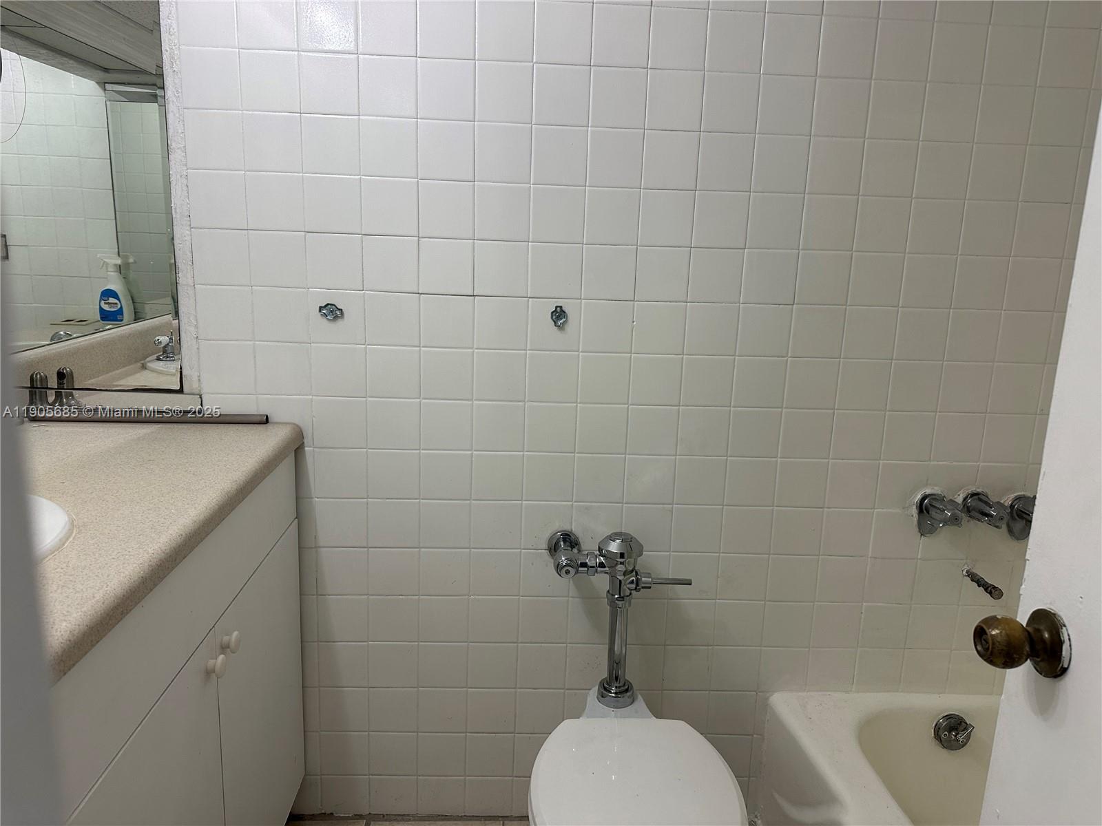 26 Diplomat Parkway, Unit 2314 Hallandale Beach, FL 33009 - Photo 11 of 15 a bathroom with a sink a toilet and shower