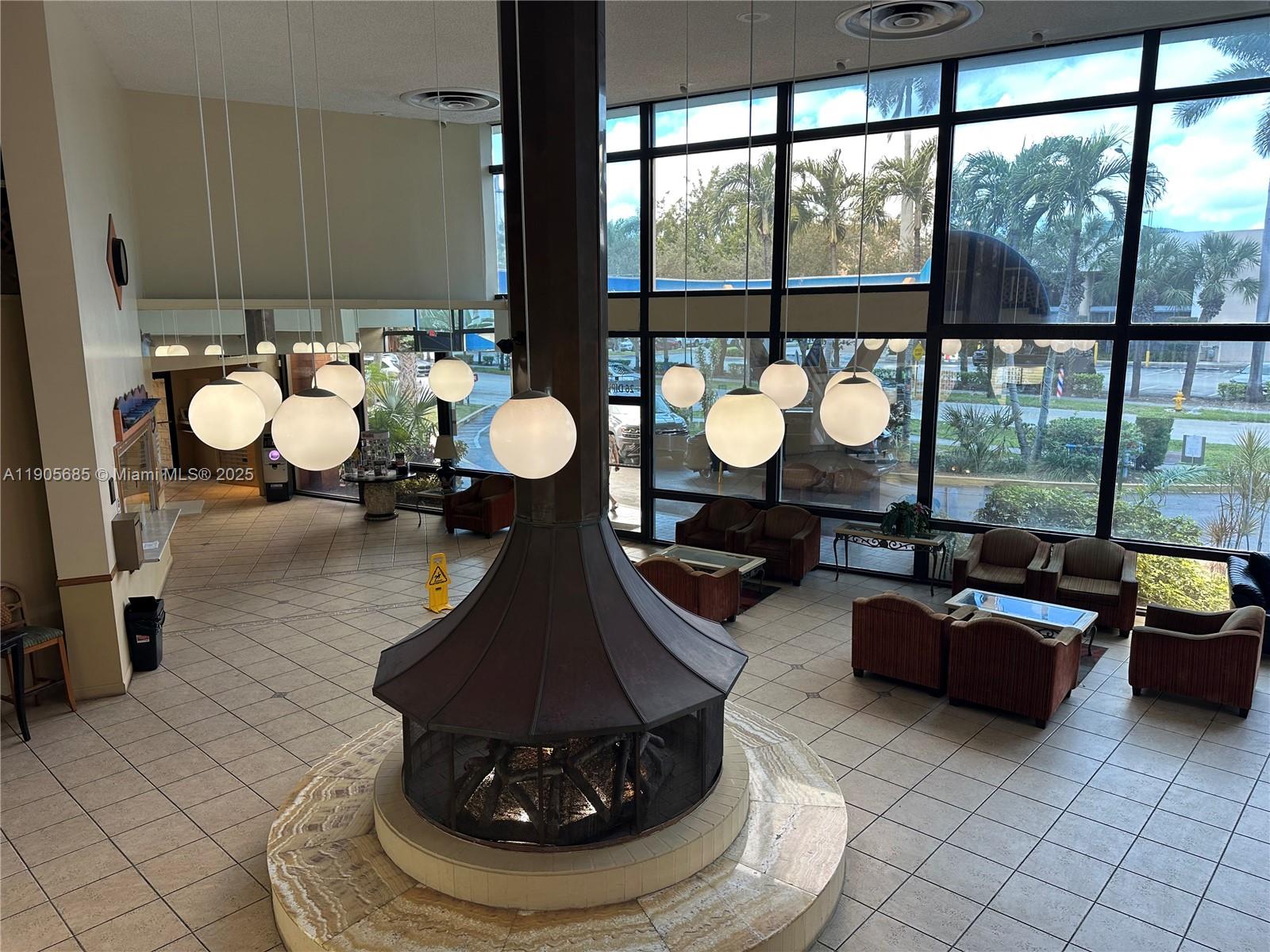26 Diplomat Parkway, Unit 2314 Hallandale Beach, FL 33009 - Photo 12 of 15 a living room with furniture and a large window