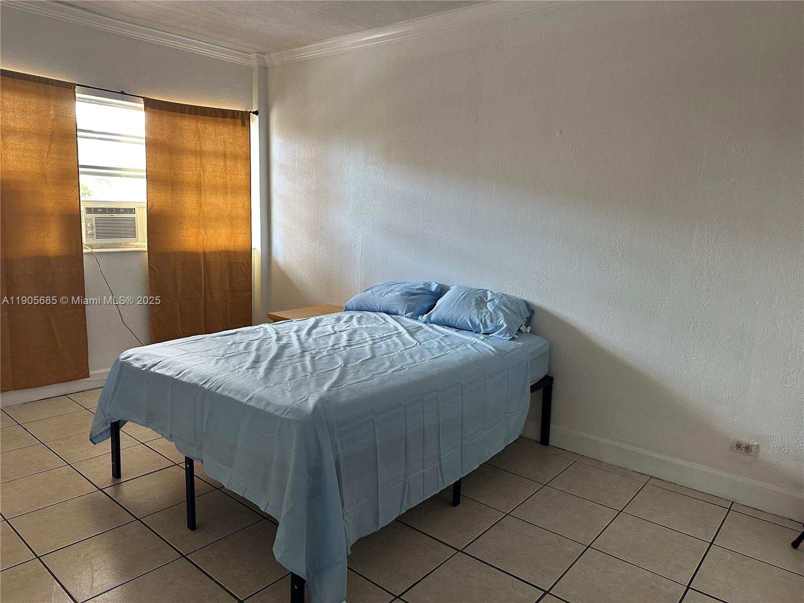 26 Diplomat Parkway, Unit 2314 Hallandale Beach, FL 33009 - Photo 15 of 15 a bedroom with a bed and a window