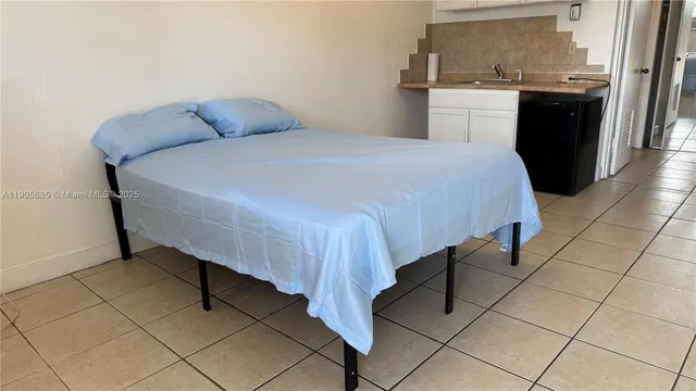 a bedroom with a bed and a stove top oven