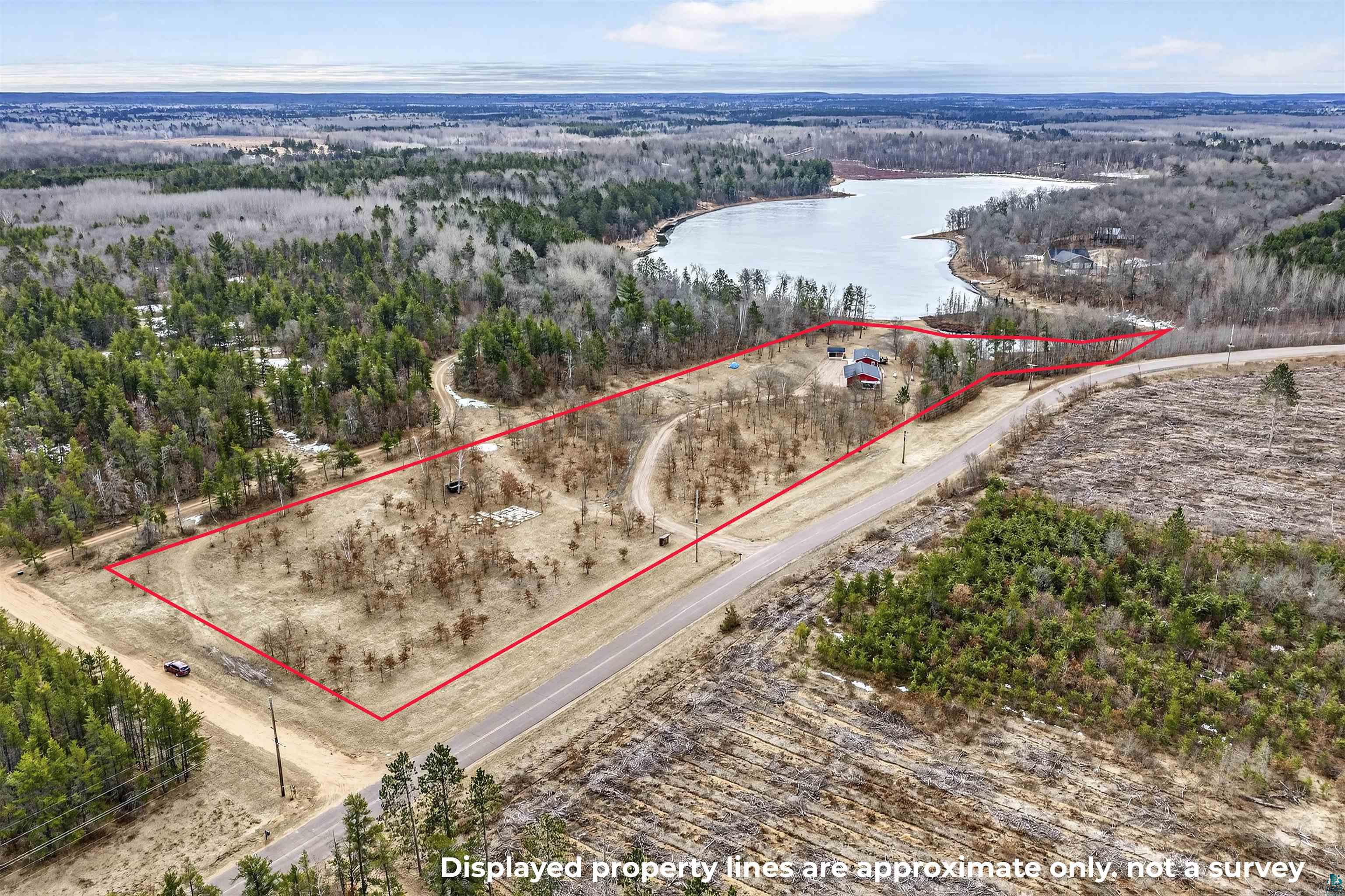11702 East Mail Road Gordon, WI 54838 - Photo 27 of 49 Aerial view of property and surrounding area featuring property parcel outlined and a nearby body of water