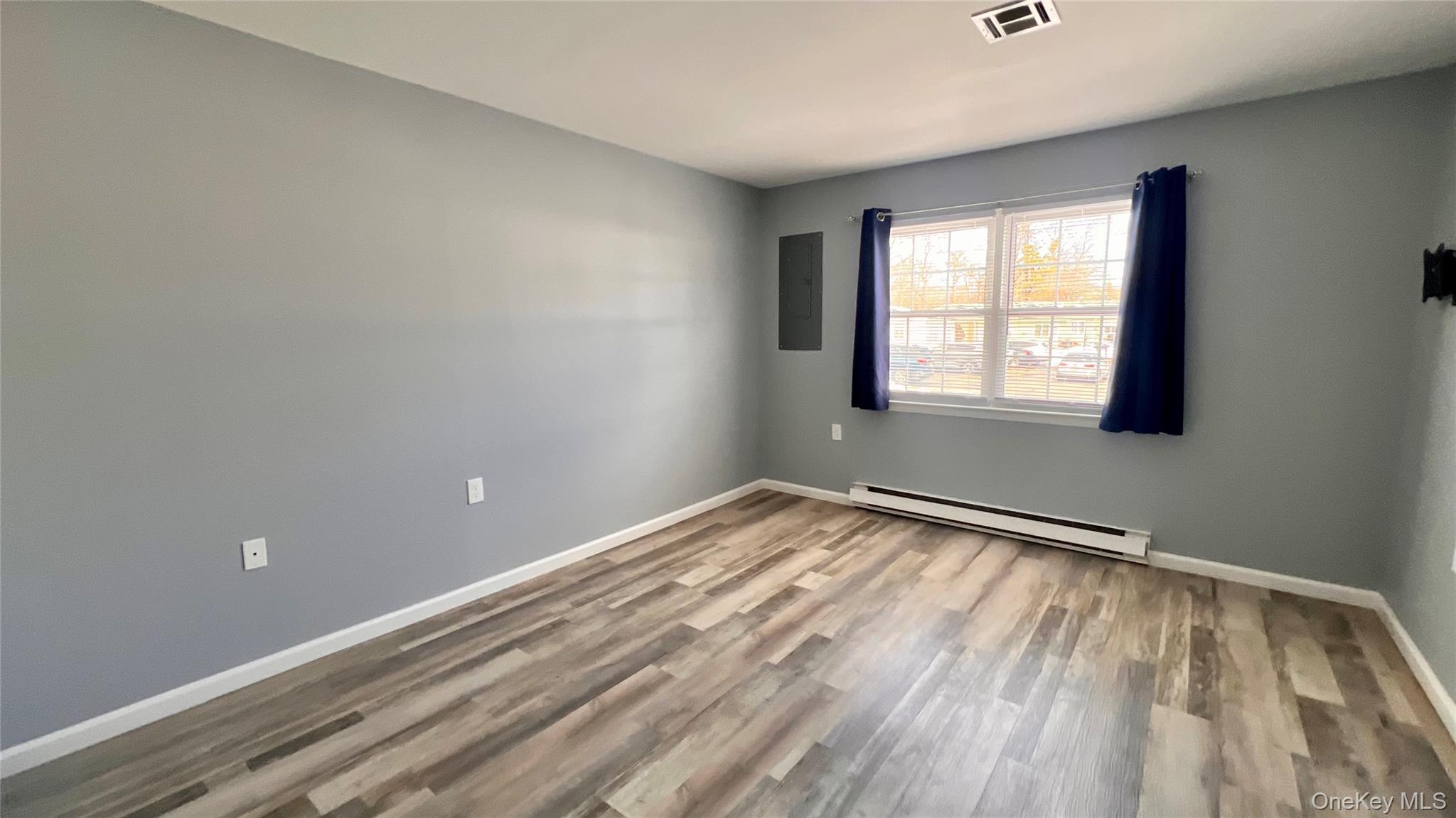 421 Weymouth Court, Unit D Ridge, NY 11961 - Photo 11 of 21 a view of an empty room and window