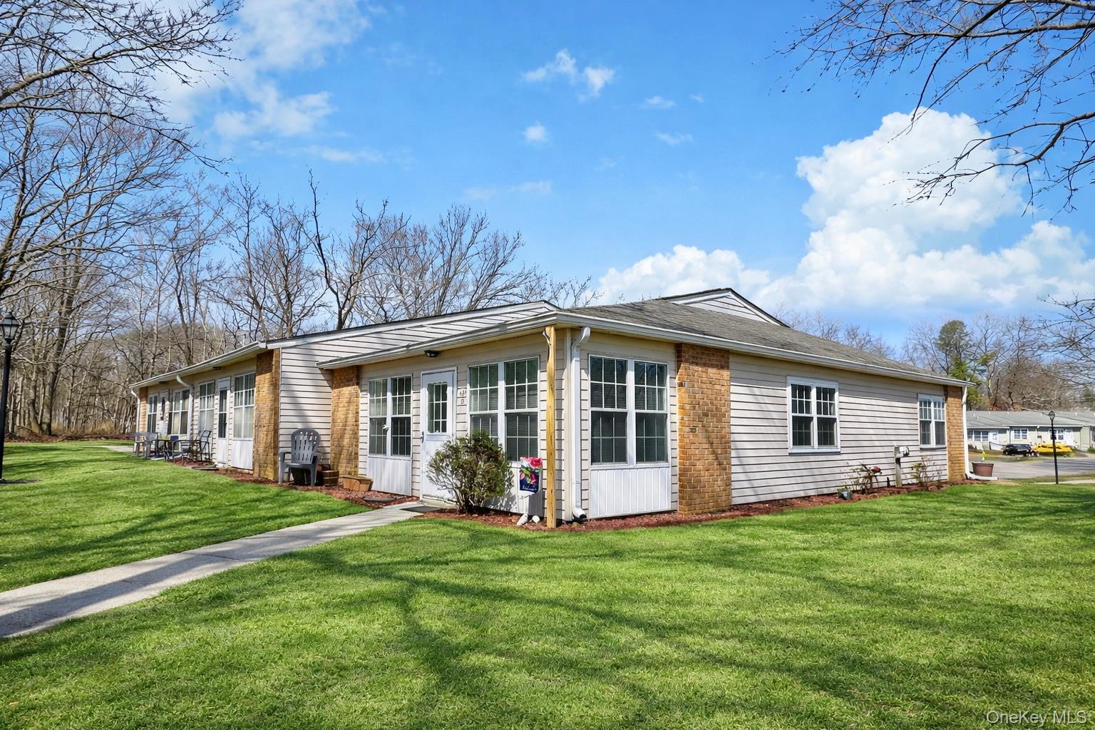 421 Weymouth Court, Unit D Ridge, NY 11961 - Photo 3 of 21 a view of a house with backyard and garden