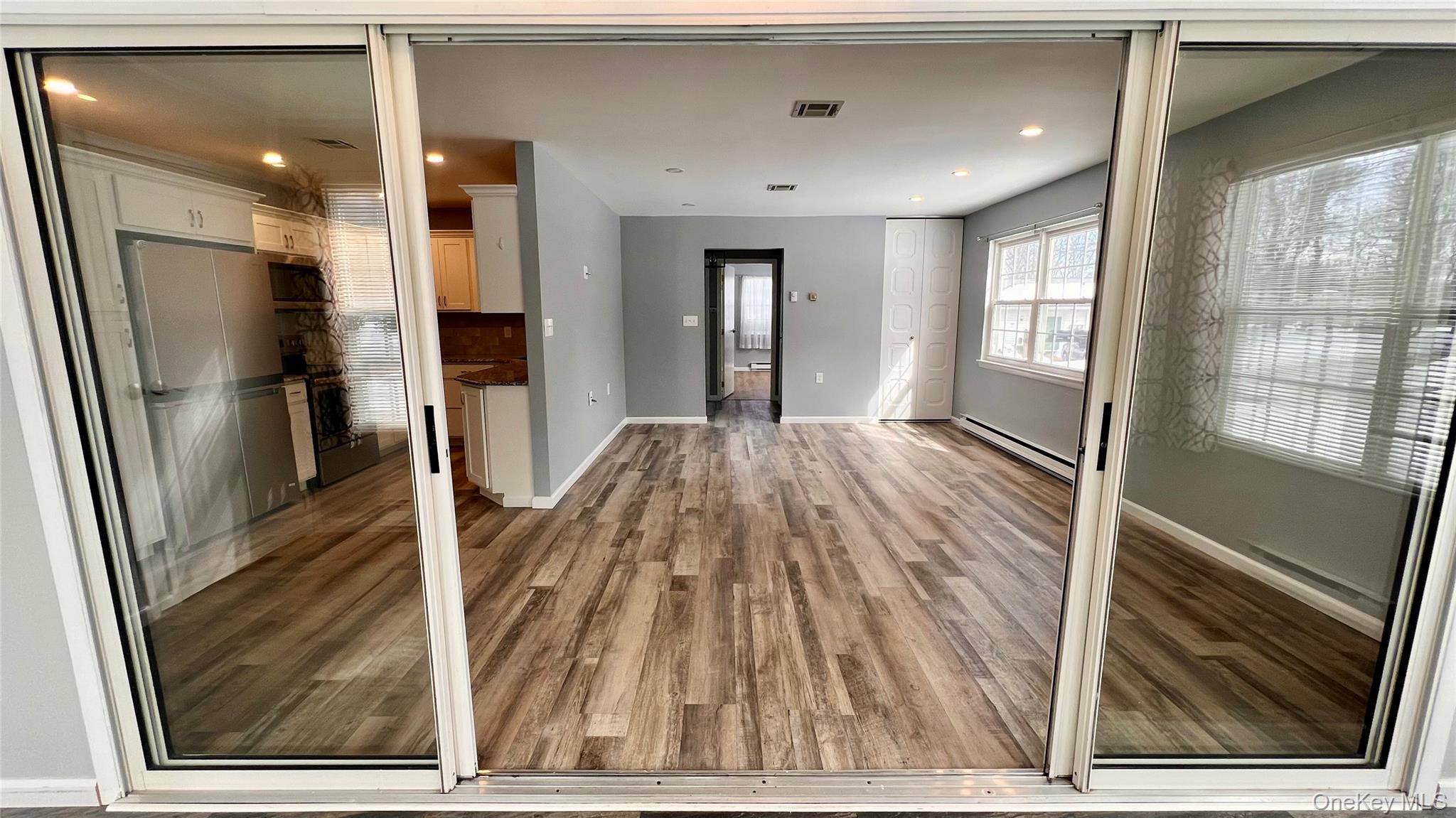 421 Weymouth Court, Unit D Ridge, NY 11961 - Photo 6 of 21 a view of a kitchen from the hallway