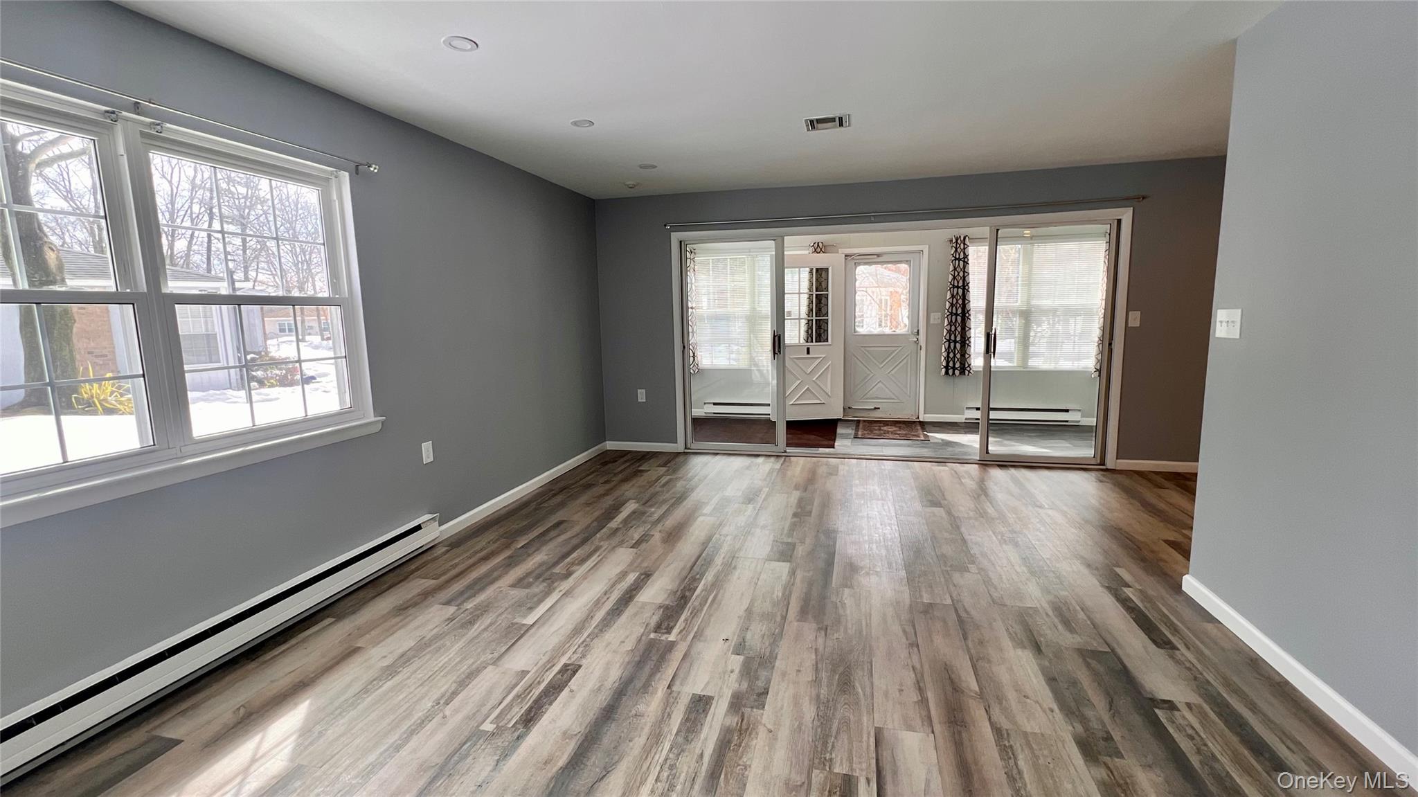 421 Weymouth Court, Unit D Ridge, NY 11961 - Photo 8 of 21 a view of a room with wooden floor and cabinets