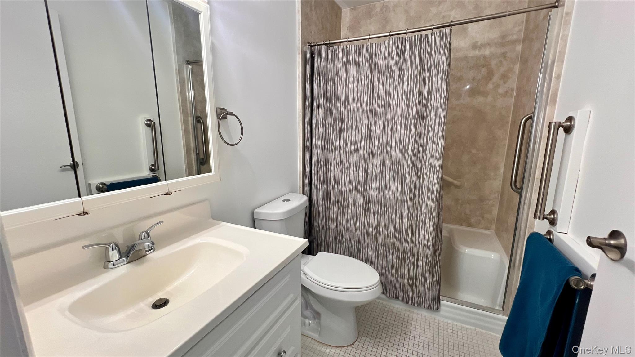 421 Weymouth Court, Unit D Ridge, NY 11961 - Photo 9 of 21 a bathroom with a sink a toilet and shower