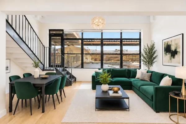 a living room with furniture and floor to ceiling windows