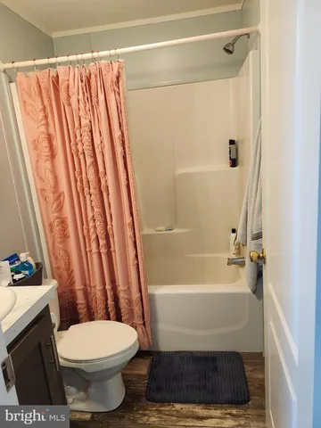 a bathroom with a toilet and a shower curtain