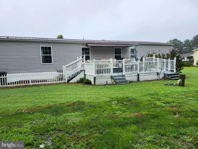 a view of a house with a backyard and a patio