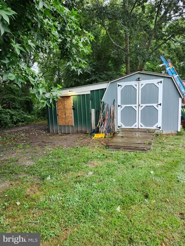 a view of backyard with small cabin