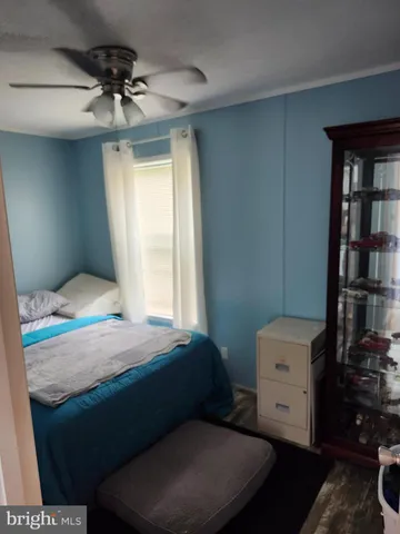 a bedroom with a bed and a bookshelf