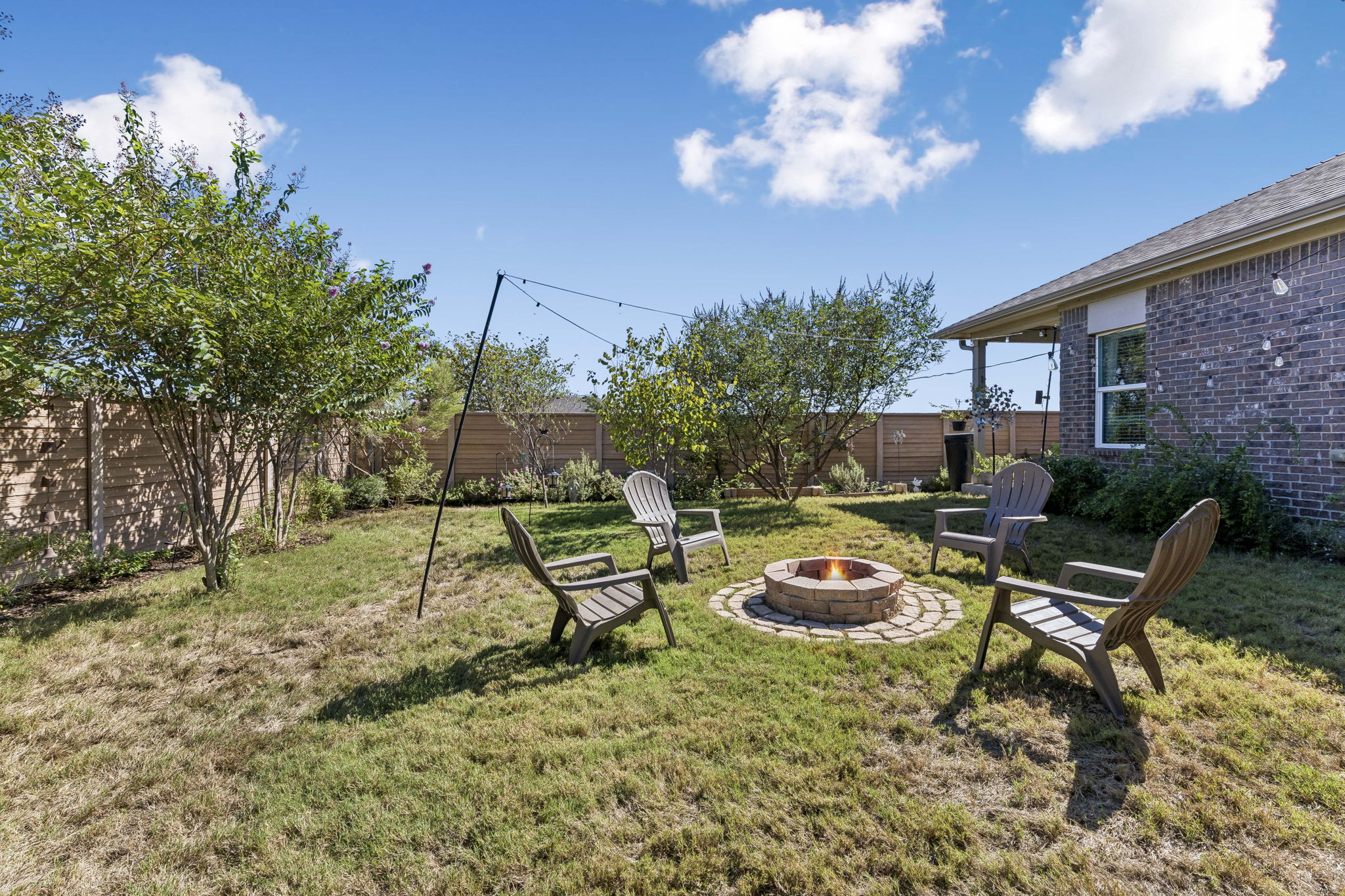124 Moravia Road Georgetown, TX 78626 - Photo 36 of 38 A spacious grassy lawn provides a private outdoor retreat framed by brick and wood fencing.