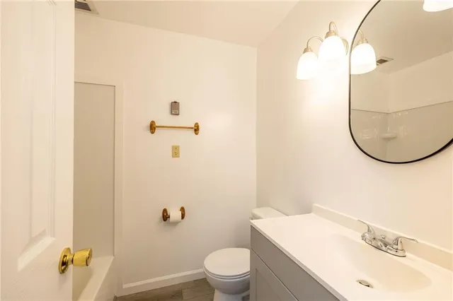 a bathroom with a sink a toilet and shower curtain