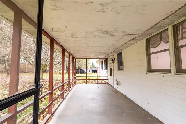 an aerial view of a house with a yard and lake view