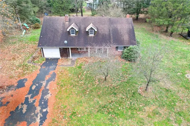 an aerial view of a house with a yard