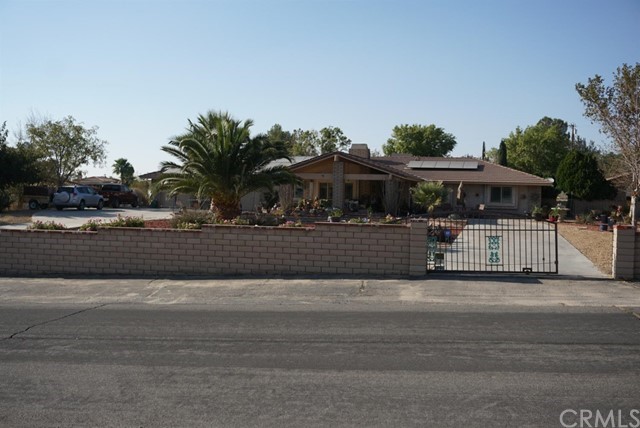19580 Yanan Road Apple Valley, CA 92307 - Photo 1 of 1 a front view of a house with a yard and fountain
