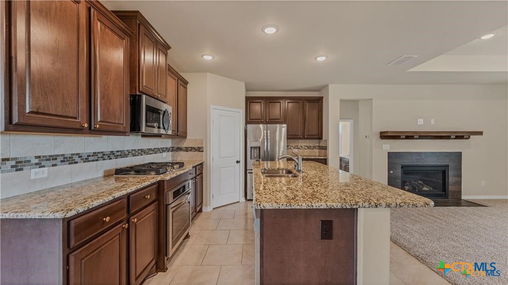 559 Bylerpool Road Kingsbury, TX 78638 - Photo 20 of 36 a kitchen with stainless steel appliances granite countertop a stove sink and cabinets