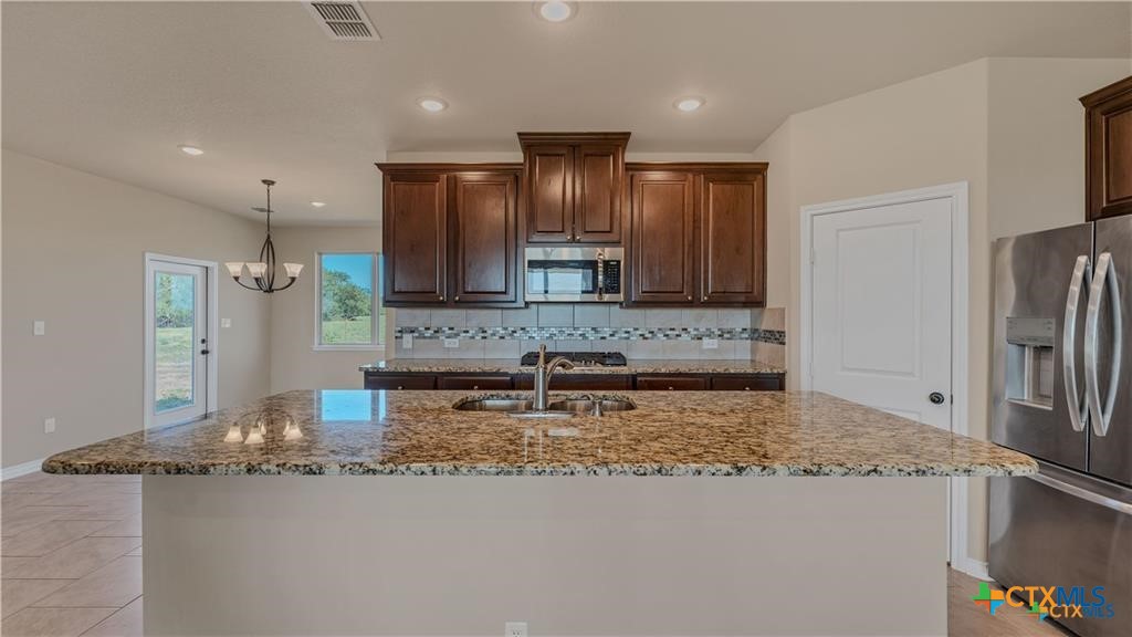 559 Bylerpool Road Kingsbury, TX 78638 - Photo 25 of 36 a bathroom with a granite countertop sink and a large mirror