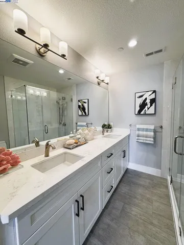 a spacious bathroom with a double vanity sink mirror and double