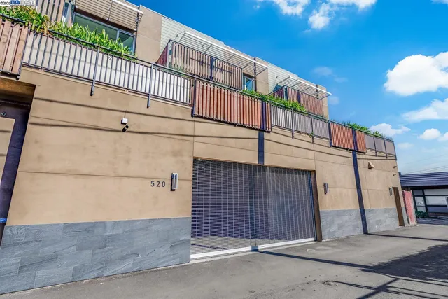 a view of a street with wooden fence