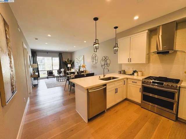 a kitchen with stove and cabinets
