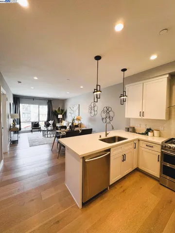 a large kitchen with stainless steel appliances lots of counter space and windows