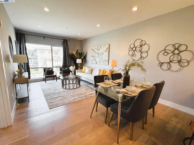 a living room with fireplace furniture and a large window