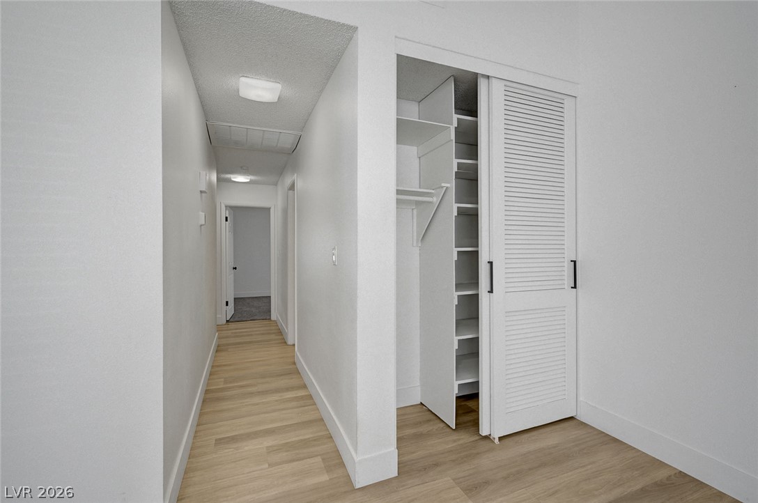 4840 Summerhill Road Las Vegas, NV 89121 - Photo 22 of 56 Functional hallway closet with ample shelving and a clothing rod offers convenient storage solutions.