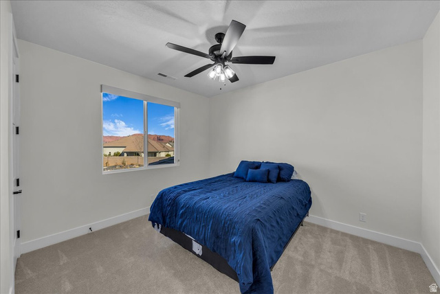 404 North Marsala Way St. George, UT 84770 - Photo 20 of 26 Bedroom with light carpet and ceiling fan