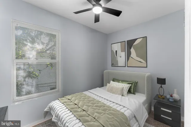 a bedroom with a large bed and a window