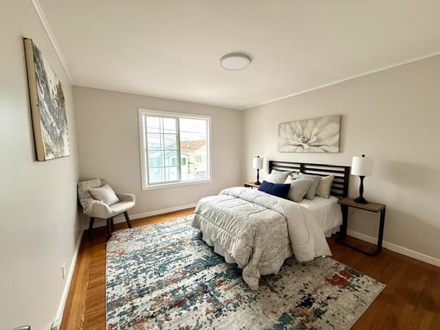 135 Bepler Street Daly City, CA 94014 - Photo 8 of 34 a bedroom with a bed and wooden floor