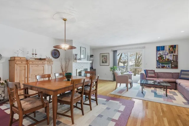 a dining room with furniture a rug and wooden floor