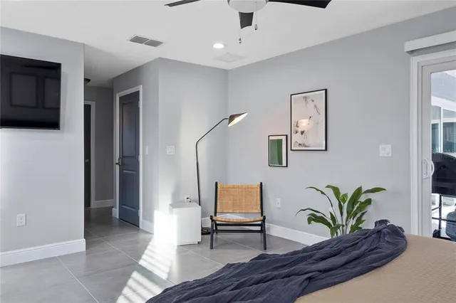 a bedroom with a bed and a large window