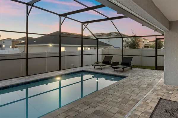 a view of a swimming pool with a lounge chair