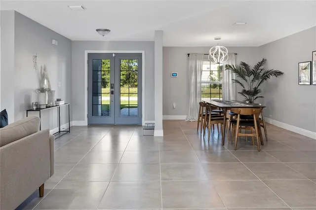 a dining room with furniture and window