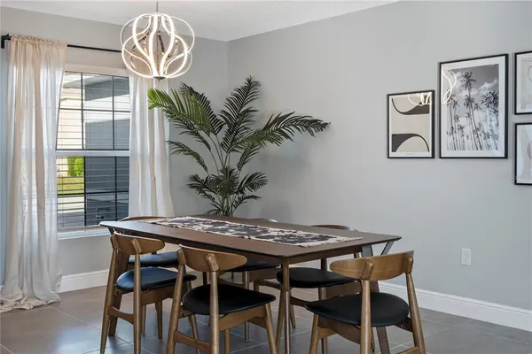 a view of a dining room with furniture and chandelier