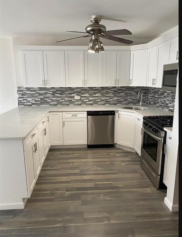 7000 Boulevard East, Unit 29I Guttenberg, NJ 07093 - Photo 2 of 16 a kitchen with granite countertop a stove top oven sink and cabinets