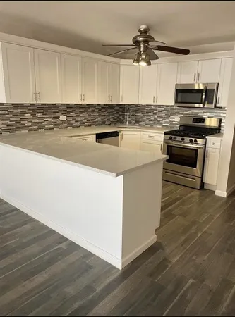 a view of kitchen with wooden floor
