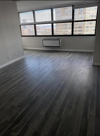 wooden floor and window in an empty room