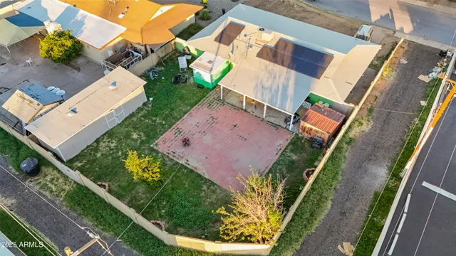 an aerial view of a house with a yard and pool