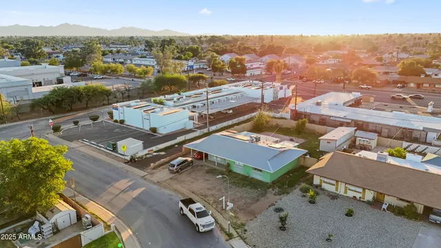 a kitchen with stainless steel appliances kitchen island granite countertop a table chairs stove and white cabinets