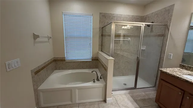a bathroom with a tub sink and shower